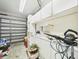 Well-lit garage featuring ample storage with white cabinets, shelving, and smooth concrete floors, providing functionality at 3690 Wellington Pl, Bartow, FL 33830