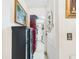 Hallway with storage cabinet, framed art, leading to a closet storage area at 3690 Wellington Pl, Bartow, FL 33830