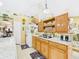 Bright kitchen featuring oak cabinetry, granite countertops, and plentiful counter space at 3690 Wellington Pl, Bartow, FL 33830