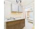 Compact kitchenette featuring a sink, cabinets, and an open view into the next room at 3690 Wellington Pl, Bartow, FL 33830