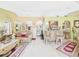 Open concept living room with tile flooring, high ceiling, and many decorations at 3690 Wellington Pl, Bartow, FL 33830