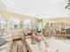 Spacious living room featuring tile floors, arched wall accents, and comfortable leather seating at 3690 Wellington Pl, Bartow, FL 33830