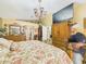 Large main bedroom featuring detailed furnishings and an ornate chandelier at 3690 Wellington Pl, Bartow, FL 33830