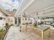 Covered patio with tiled floor featuring chandelier, ceiling fans, and plants for outdoor relaxation at 3690 Wellington Pl, Bartow, FL 33830