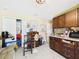 Room with storage and kitchenette, featuring dark-wood cabinetry and a range of household items at 3690 Wellington Pl, Bartow, FL 33830