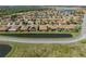 Aerial view of a single Gathering home with a waterfront view and tropical landscaping in a gated community at 4115 Muirfield Loop, Lake Wales, FL 33859