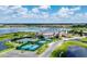 An aerial view of the community clubhouse, lake, and surrounding neighborhood at 4115 Muirfield Loop, Lake Wales, FL 33859