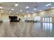 The large auditorium with a stage, tables, chairs, and large windows at 4115 Muirfield Loop, Lake Wales, FL 33859