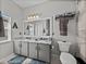 Neutral colored bathroom features double sinks, granite countertops, and ample storage space at 4115 Muirfield Loop, Lake Wales, FL 33859