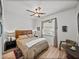 Bedroom with hardwood floors, side tables with lamps and natural light from the window at 4115 Muirfield Loop, Lake Wales, FL 33859