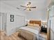 Bedroom featuring hardwood floors, ceiling fan, a closet and neutral colored walls at 4115 Muirfield Loop, Lake Wales, FL 33859