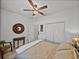 Bedroom with hardwood floors, ceiling fan, closet, neutral walls and small table at 4115 Muirfield Loop, Lake Wales, FL 33859