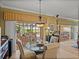 Well-lit dining area with stylish decor, comfortable seating, and views of a tranquil water view at 4115 Muirfield Loop, Lake Wales, FL 33859