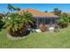 Charming backyard showcasing a screened lanai, lush landscaping, and a tranquil setting for relaxation at 4115 Muirfield Loop, Lake Wales, FL 33859