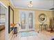 Inviting foyer with decorative mirrors, crown molding, and a view to another room at 4115 Muirfield Loop, Lake Wales, FL 33859