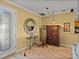 The spacious foyer boasts wood floors, decorative mirror, and convenient access to the kitchen at 4115 Muirfield Loop, Lake Wales, FL 33859