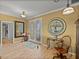 This light-filled foyer features a decorative mirror, stylish light fixtures, and wood floors at 4115 Muirfield Loop, Lake Wales, FL 33859