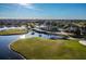 Scenic aerial view of a golf course with lush greens, sparkling ponds, and mature trees at 4115 Muirfield Loop, Lake Wales, FL 33859
