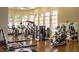 A gym with exercise equipment, mirrors and large windows for natural light at 4115 Muirfield Loop, Lake Wales, FL 33859