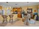 Charming kitchen and dining area with granite countertops, wood cabinets, and counter seating at 4115 Muirfield Loop, Lake Wales, FL 33859