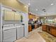 Updated kitchen with wood cabinets, granite countertops, stainless steel appliances and adjacent laundry room at 4115 Muirfield Loop, Lake Wales, FL 33859