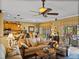 Spacious living room boasts a ceiling fan and an open floor plan with kitchen and dining spaces at 4115 Muirfield Loop, Lake Wales, FL 33859