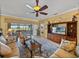 Comfortable living room featuring tile floors, ceiling fan, and view of the outdoors at 4115 Muirfield Loop, Lake Wales, FL 33859