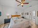 A bright main bedroom with a ceiling fan, wood-look floors, and a king-size bed at 4115 Muirfield Loop, Lake Wales, FL 33859