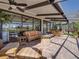 Screened-in patio offers plenty of seating and an outdoor fire pit with scenic views of the lake at 4115 Muirfield Loop, Lake Wales, FL 33859