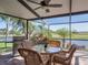 Relaxing outdoor patio featuring an outdoor dining area and a grill overlooking the pond at 4115 Muirfield Loop, Lake Wales, FL 33859