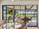 Relaxing screened-in patio with an outdoor kitchen and views of the beautiful landscaping and pond at 4115 Muirfield Loop, Lake Wales, FL 33859