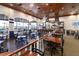 Warm and inviting restaurant featuring dark wood furniture, a bar, and views of a lake through large windows at 4115 Muirfield Loop, Lake Wales, FL 33859