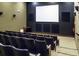 A small, intimate screening room with cushioned chairs and a screen for presentations or movies at 4115 Muirfield Loop, Lake Wales, FL 33859