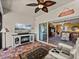 Comfortable sunroom featuring a fireplace, television, and sliding glass doors leading to the home's interior at 4115 Muirfield Loop, Lake Wales, FL 33859