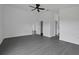 Spacious bedroom featuring modern gray floors, a ceiling fan, and crisp white walls at 412 Savanna Pointe St, Winter Haven, FL 33884