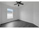 Cozy bedroom with sleek floors and a window overlooking the yard and neighborhood at 412 Savanna Pointe St, Winter Haven, FL 33884