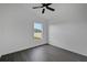 Bright bedroom with sleek floors and a window overlooking the lush yard and fence at 412 Savanna Pointe St, Winter Haven, FL 33884