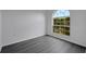 Cozy bedroom features gray floors and a garden window with a view of the outdoors at 412 Savanna Pointe St, Winter Haven, FL 33884