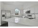 Well-lit kitchen featuring stainless steel appliances and a peninsula with a sink at 412 Savanna Pointe St, Winter Haven, FL 33884