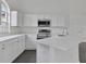 Modern kitchen offering white countertops, stainless steel appliances and ample cabinetry at 412 Savanna Pointe St, Winter Haven, FL 33884