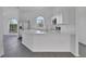 Beautiful white kitchen boasts waterfall countertops and stainless steel appliances at 412 Savanna Pointe St, Winter Haven, FL 33884