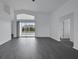 Open living space featuring contemporary flooring and a large sliding glass door at 412 Savanna Pointe St, Winter Haven, FL 33884