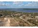 Aerial view of a home in a residential area near a lake, surrounded by lush greenery and other houses at 42 Mountain Dr, Babson Park, FL 33827