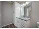 Bathroom vanity with white cabinets, gray granite countertops, and a decorative mirror at 42 Mountain Dr, Babson Park, FL 33827
