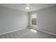 Neutral bedroom featuring carpet, light grey walls, and one large window at 42 Mountain Dr, Babson Park, FL 33827