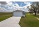 New construction home with a well-manicured lawn and long driveway at 42 Mountain Dr, Babson Park, FL 33827