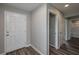 Hallway leading to bedrooms featuring wood-look floors with white doors and light gray walls at 42 Mountain Dr, Babson Park, FL 33827