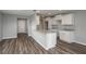 Modern kitchen with white cabinets, granite countertops, stainless steel sink, and wood-look flooring at 42 Mountain Dr, Babson Park, FL 33827