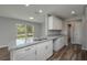 Bright kitchen with white cabinets and gray granite countertops at 42 Mountain Dr, Babson Park, FL 33827