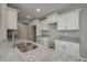 Bright kitchen with white cabinets and gray granite countertops at 42 Mountain Dr, Babson Park, FL 33827